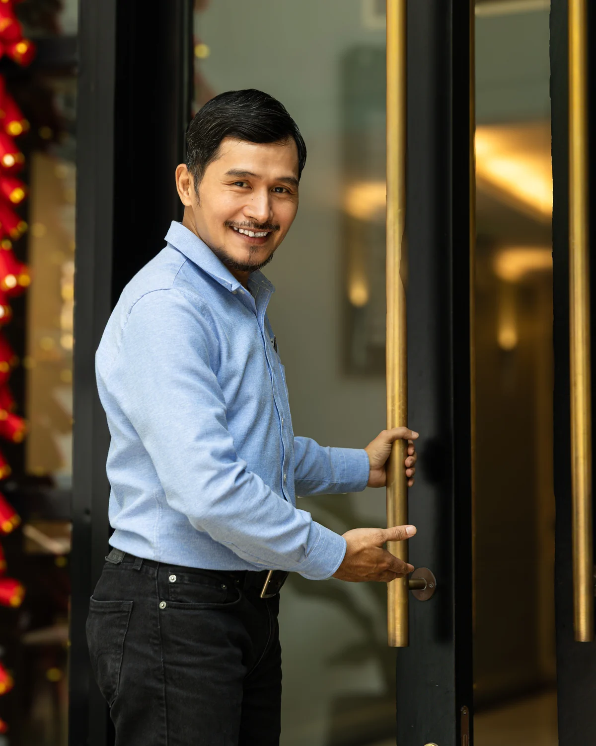 Legacy Asset team member welcoming a guest at Lafayette De Saigon